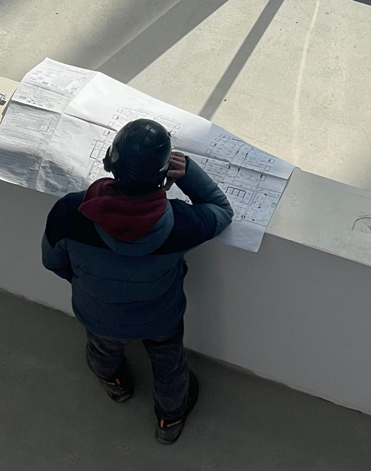 Tecnico HH che consulta il progetto elettrico in cantiere